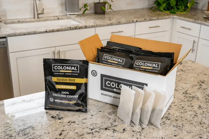 Colonial Coffee Roasters subscription box unboxing on a kitchen counter