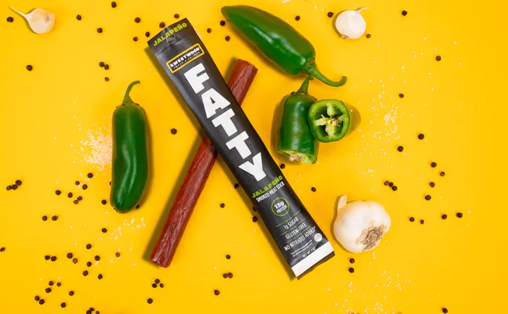 Beef stick snack flat lay with jalapenos and garlic, product photography by Evolve Media